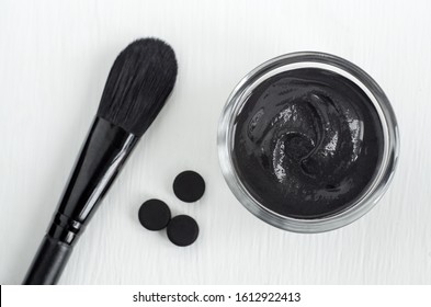 DIY Activated Charcoal Peel Off Mask In The Small Glass Bowl. Homemade Beauty Treatment. Top View, Copy Space.