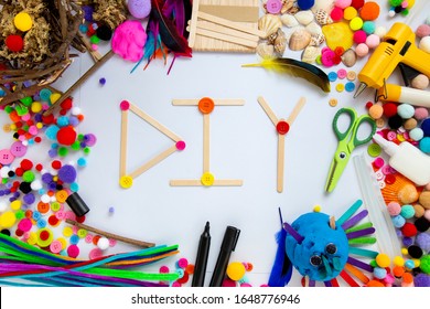 DIY Art And Craft Sign In Playdough Letters With Various Art Materials And Tools In The Background