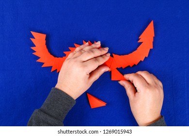 Diy Chinese Dragon On Blue Background. Gift Ideas, Decor Chinese New Year. Handmade Red Gold Lunar Dragon Lion From Modular Origami. Step By Step. The Process Of Crafts. Top View.