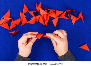 Diy Chinese Dragon On Blue Background. Gift Ideas, Decor Chinese New Year. Handmade Red Gold Lunar Dragon Lion From Modular Origami. Step By Step. The Process Of Crafts. Top View.