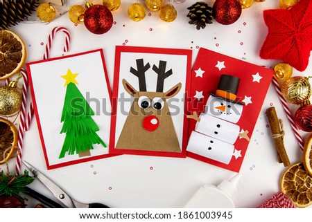 DIY Christmas cards kids. Three cards with a Christmas tree, a deer, a snowman from colored paper.