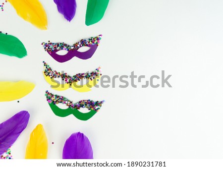 DIY colored Mardi Gras mask. Workplace with colored paper, feathers, confetti, glitter and scissors. Party preparation. Shrove Tuesday, Fat Tuesday. Flat lay