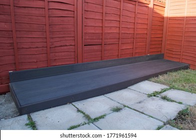 DIY composite decking built to cover a concrete ledge. - Shutterstock ID 1771961594