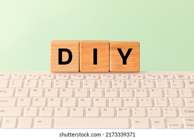 DIY Computer Abbreviation For Do It Yourself, Inscription On Wooden Blocks And A Computer Keyboard