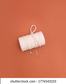 DIY Concept Image With Macrame Thread, Small Gold Scissors And A Golden Key Chain, Flat Lay Creative Project Concept Image On Orange Background