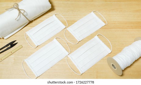 DIY Cotton Pleated Mask And Handicraft Tools On The Wooden Table. Handmade Concept.