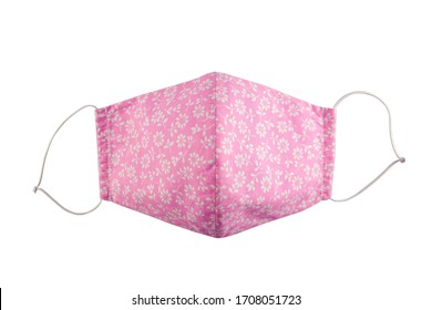 DIY (Do it yourself) face medical mask isolated on white. Pattern of white flowers on pink mask. Concept of coronavirus infection prevention.