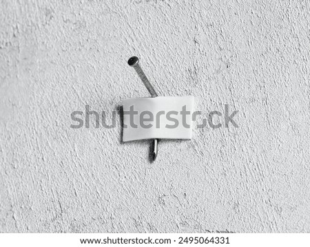 DIY do it yourself repairs, problems and failures. Expectation ve reality.  Nail mounted on a white wall with a white adhesive tape.
