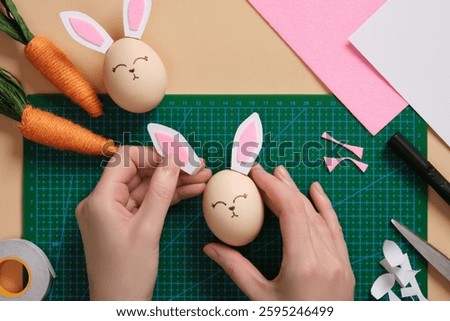 DIY Easter Bunny Egg Craft. Step-by-step instructions. Glue the ears to the egg with double-sided tape.