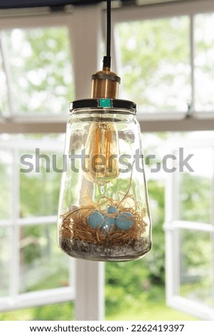 Similar – Image, Stock Photo A lamp made of rattan or something like that hangs between the wallpaper with a wild pattern that is coming loose and hanging in tatters from the ceiling.