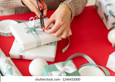 DIY Gift Wrapping. Unrecognisable Woman Wrapping Beautiful Nordic Style Christmas Gifts. Hands Close Up.