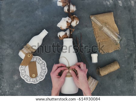DIY glass bottle with burlap, handmade vase. Decor, rustic style, design, homemade idea. Flat lay. Top view. Copy space 