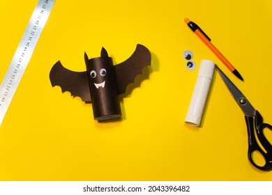 Diy Halloween Bat From Toilet Tube And Craft Paper On Yellow Orange Background. Halloween Holiday Concept. Step 8. The Paper Bat Is Ready. Children's Art Project. DIY Concept.