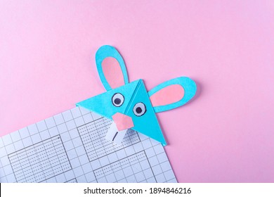 DIY and kid's creativity, origami. Step by step instruction: how to make bookmark easter bunny. Step 9 Finished bookmark for book, funny rabbit. Easter craft