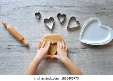 DIY making gingerbread by kid for Valentine's Day for parents. Baking training for children from 4 to 14 years old. early child development of fine motor skills. step by step. step 2. view from above