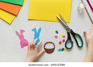 DIY Postcard Step By Step. Card Happy Easter With Child Hands. Crafts Concept For Kids. Step 4. Cut Out Rabbits, Bunny, Eggs, Basket.