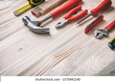 DIY, repair, service concept. Hand tools set red and yellow color on wood, copy space, close up view. - Powered by Shutterstock