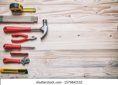 DIY, repair, service concept. Hand tools set red and yellow color on wood, copy space, top view.