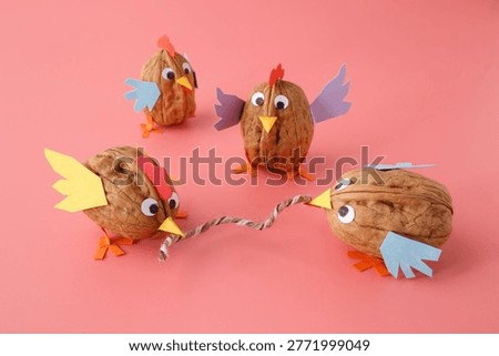 Diy walnut shell chickens group with colorful wings. Perfect for early childhood development, creative workshops, craft blogs, toy stores, or sustainable eco-friendly parenting content and ads.