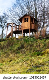 DIY Wooden Playhouse For Children With Swing And Slide On A Hillside In A Sunny Day