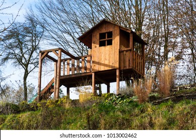 DIY Wooden Playhouse For Children With Swing And Slide On A Hillside In A Sunny Day