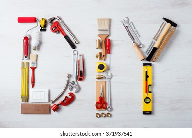 DIY word composed of work and construction tools on a wooden surface top view, hobby and craft concept