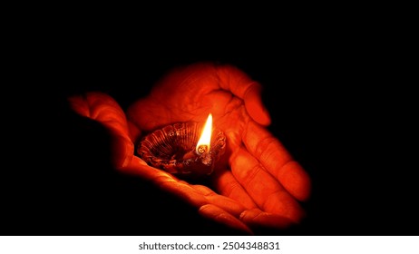 Diya with hand finger, this is dark background diya on hand, is very important for Diwali festival for mak like brite inbiranment, and Welcome Home - Powered by Shutterstock