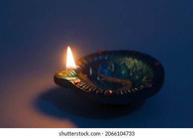 Diya lamp with fire. Traditional Divali festival. Close up.