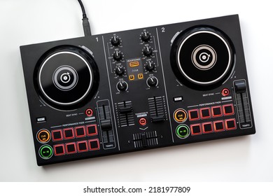 DJ Colorful mixing deck Controller connecting to Laptop and tablet using USB cable top view, isolated on white.