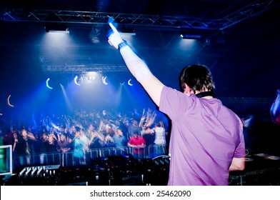 Dj At The Concert, Blurred Crowd On Background