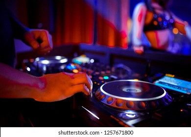 DJ Console Cd Mp4 Deejay Mixing Desk Ibiza House Music Party In Nightclub With Colored Disco Lights.