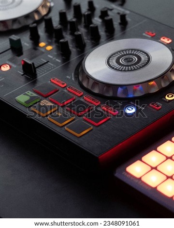 DJ controller close up view in live performance night club dance music.