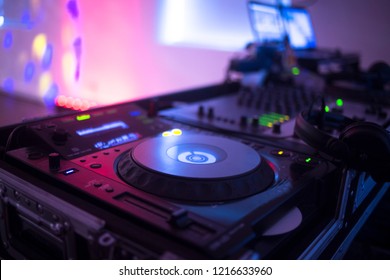 DJ deejay mixing desk equipment in wedding receoption party disco with color discotheque lights.