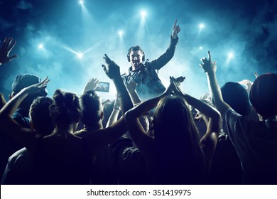 Dj in front of crowd - Shutterstock ID 351419975