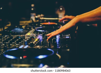 Dj Hands Close Up On A Mixer And Turntables During Music Set 