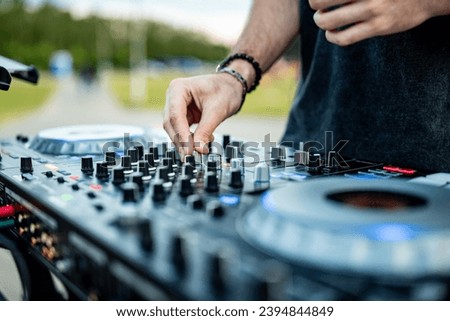 DJ Hands creating and regulating music on dj console mixer in concert