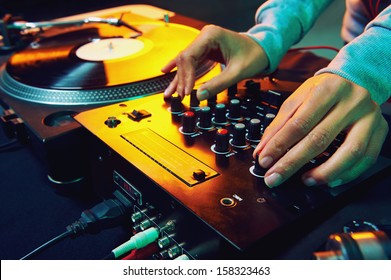 Dj Hands On Equipment Deck And Mixer With Vinyl Record At Party