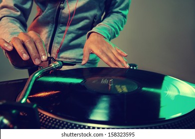 Dj Hands On Equipment Deck And Mixer With Vinyl Record At Party