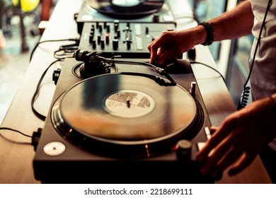 Dj Hands On Equipment Deck And Mixer With Vinyl Record At Party, Human Hands Using Two Vinyl Turn Table Players Playing Songs In Succession.