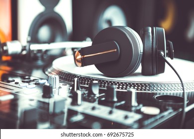 Dj headphones on turntable. Disc jockey audio equipment in close up - Shutterstock ID 692675725