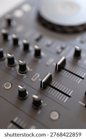Dj mixer control knobs and faders on audio deck studio.