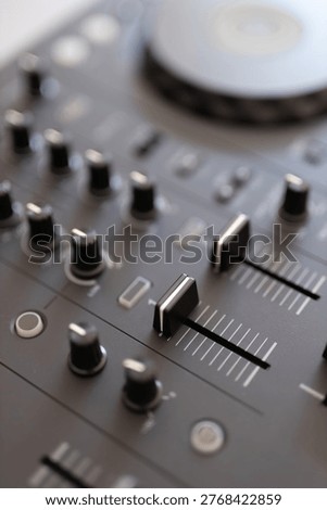 Dj mixer control knobs and faders on audio deck studio.