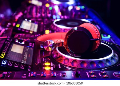 Dj mixer with headphones at nightclub
