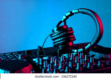 Dj Mixer With Headphones At Nightclub Party