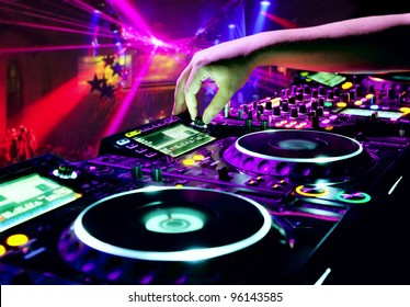 Dj Mixes The Track In Nightclub At Party