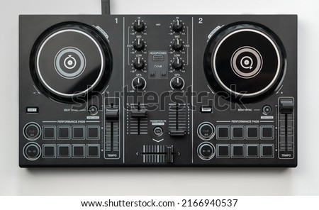 DJ mixing deck Controller connecting to Laptop and tablet using USB cable top view, isolated on white.