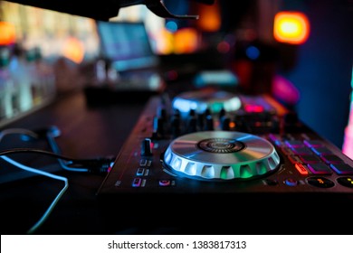 DJ mixing music on console at the night club 