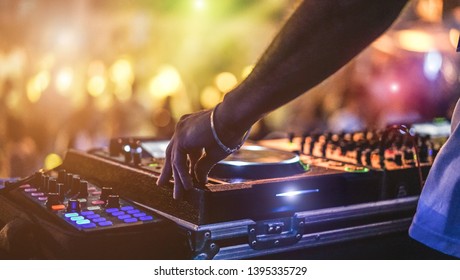 Dj Mixing Outdoor At Beach Party Festival With Crowd Of People In Background - Summer Nightlife View Of Disco Club Outside - Soft Focus On Hand - Fun ,youth,entertainment And Fest Concept