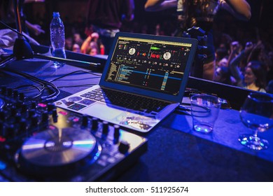 DJ Mixing Software Installed On Apple Macbook Air On Concert Stage. Professional Disc Jockey Setup In Night Club. Disk Jokey Mixer And Laptop On Party In Nightclub USA - 1 MAY,2022