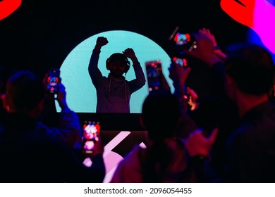 Dj Party At Nightclub. Crowd Rave At The Stage Background